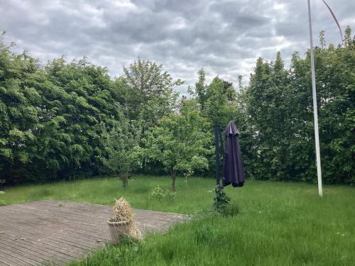 an umbrella sitting in a field of grass at 5 person holiday home in Nakskov in Nakskov