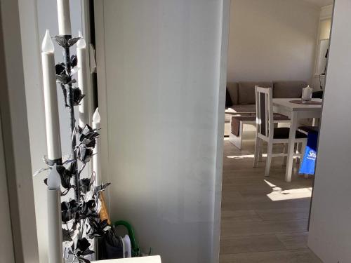 a living room with a white wall and a candle at 4 star holiday home in BRÅLANDA in Brålanda