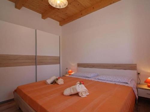 a bedroom with two beds with towels on them at Villa in minj with swimming pool in Žminj