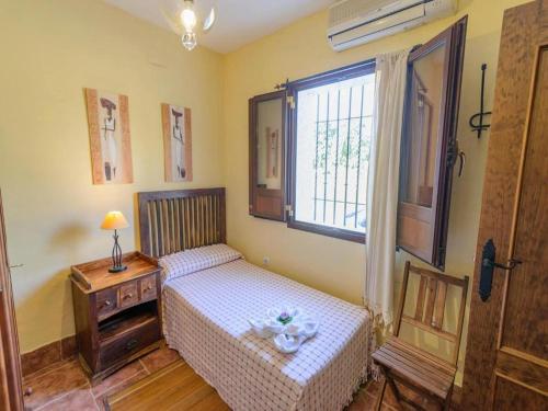 a small bedroom with a bed and a window at Studio in Spain with Private Pool and Garden in Rivero de Posadas