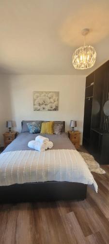 a bedroom with a bed with two towels on it at Cozy Studio Newly Furnished in Colchester