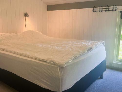 a large bed in a bedroom with a window at 6 person holiday home in Jerup in Jerup