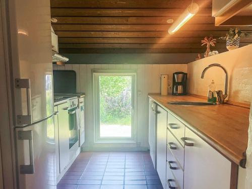 a kitchen with a counter top and a window at 6 person holiday home in Jerup in Jerup