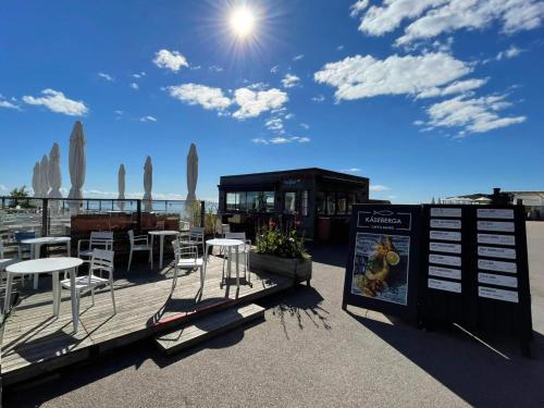 a restaurant with tables and chairs on a roof at 4 person holiday home in Köpingebro in Köpingebro