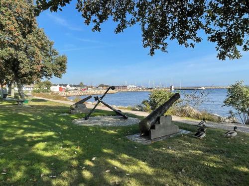 a group of sculptures on the grass near the water at 4 person holiday home in Köpingebro in Köpingebro