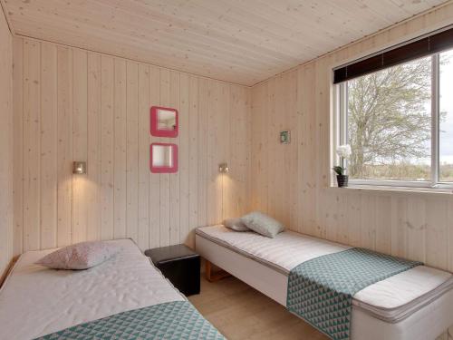 a bedroom with two beds and a window at 5 star holiday home in Bogense in Bogense