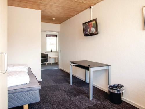 a room with a table and a bed and a picture on the wall at 5 star holiday home in Thyborøn in Thyborøn