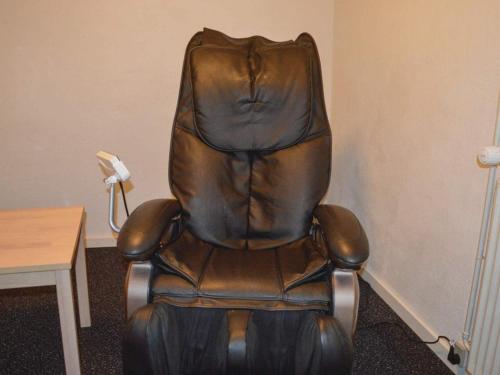 a brown leather office chair sitting next to a table at 5 star holiday home in Thyborøn in Thyborøn