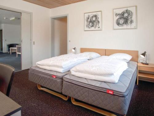 a bedroom with a bed with two pillows on it at 5 star holiday home in Thyborøn in Thyborøn