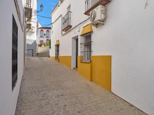 a narrow alley with a white and yellow building at Apartment in Andalusia with Scenic Views in Peñaflor
