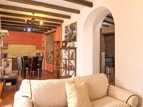 a living room with a couch and a dining room at Apartment in Andalusia with Scenic Views in Peñaflor