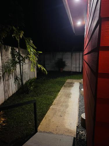 a night time view of a backyard with a house at Serenity Gardens Villa con Jacuzi in Fortuna