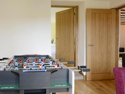 a lego foosball table in a living room at Llofft Storws in Valley
