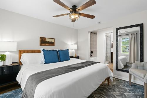 a bedroom with a large bed and a ceiling fan at New! Private Lakefront Retreat 3BR 2BA Game Room 