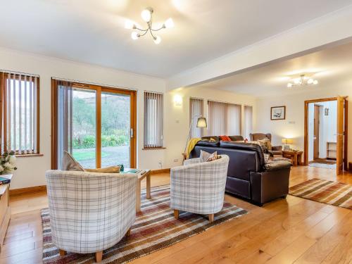 a living room with a couch and chairs at Am Bruadar in Dalmally