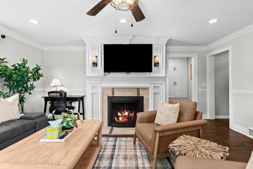 a living room with a fireplace and a tv at New! Private Lakefront Retreat 3BR 2BA Game Room 