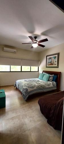 a bedroom with a bed and a ceiling fan at Private House in Playa Coronado in Nueva Gorgona