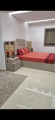 a bedroom with a large bed with red sheets at Suites au sein d'une Villa au centre ville de Rabat in Rabat