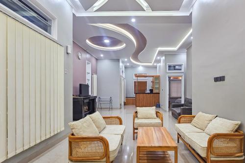 a living room with two couches and a table at Sans Vibes Hotel Sulanjana Syariah Sukabumi in Krawang