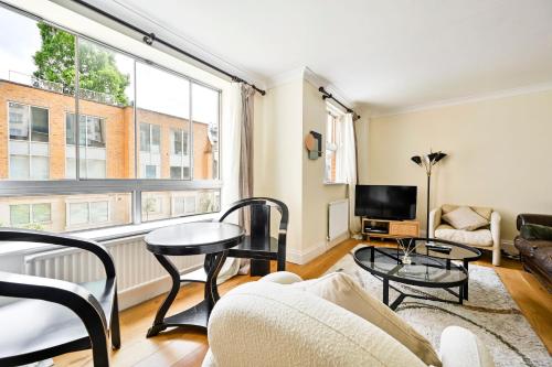 a living room with a couch and a tv at bloomrooms@Knightsbridge/HydePark in London