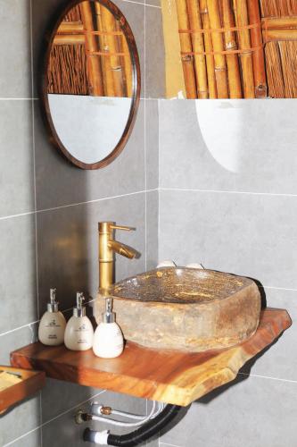 a bathroom with a sink with a wooden counter at Cat Ba Holiday Retreat in Cat Ba