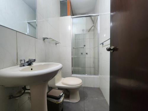 a bathroom with a sink and a toilet and a shower at Hotel San Miguel in Piura