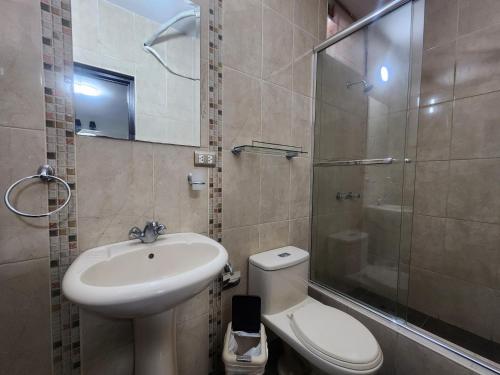 a bathroom with a sink and a toilet and a shower at Hotel San Miguel in Piura