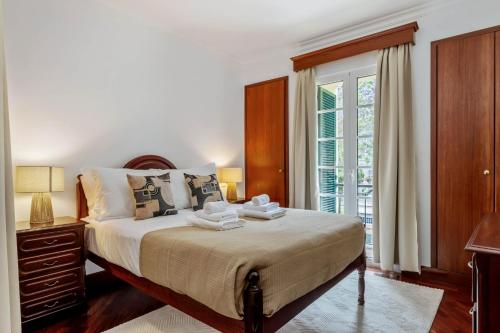 a bedroom with a large bed and a window at Pestanas Nest by Homie in Ribeira Brava