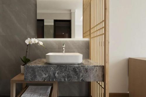 a bathroom with a sink on a marble counter at Yinxitang Aesthetic Life Courtyard Hotel Kuanzhai Alley People's Park Subway Station Branch in Chengdu