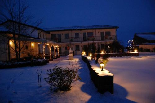 a building with lights in the snow at night at Fewo-Nordseebaer in Friedrichskoog