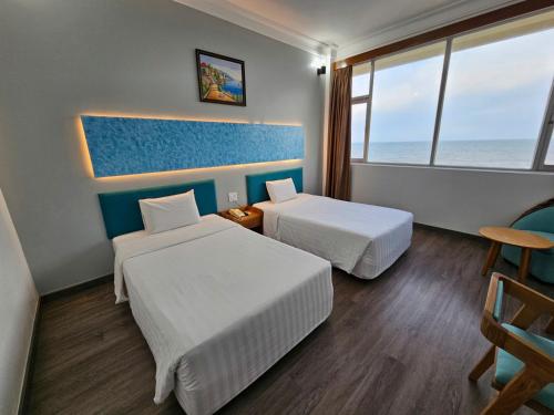 Ένα ή περισσότερα κρεβάτια σε δωμάτιο στο Sammy Hotel