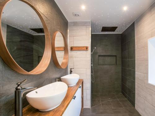 a bathroom with a sink and a shower at The Pendre Longbarn in Pentre-briwnant