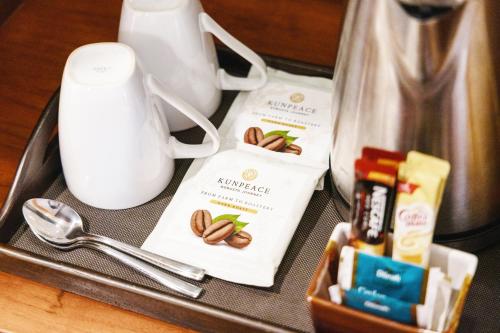 a tray with a coffee maker and products on it at Royal Phuket City Hotel in Phuket Town