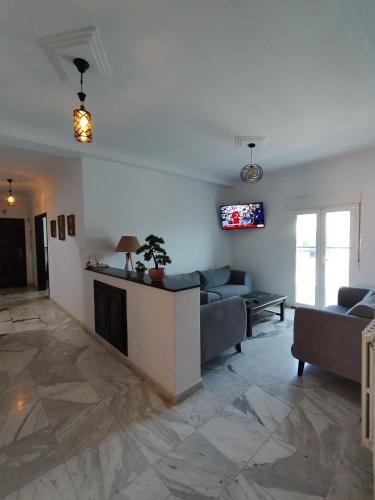a living room with couches and a fireplace at Appartement à louer à Tlemcen in Tlemcen
