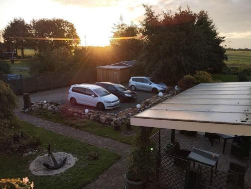 a group of cars parked in a parking lot at Fewo-Seetank in Friedrichskoog