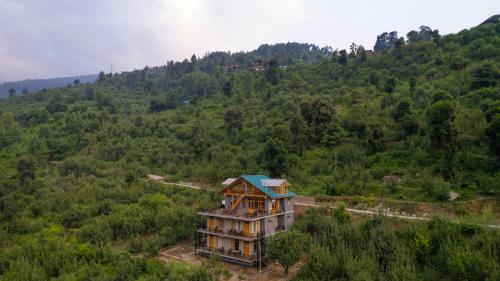 an aerial view of a house in the middle of a forest at sharan stay in Nagar