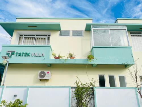 a building with a sign that reads taks villa at TATEK Villa in Kampot