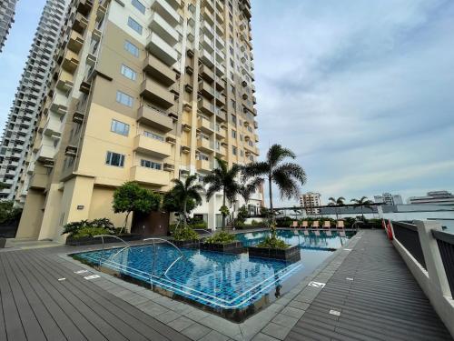 a swimming pool in front of a building at DH Suites in Manila