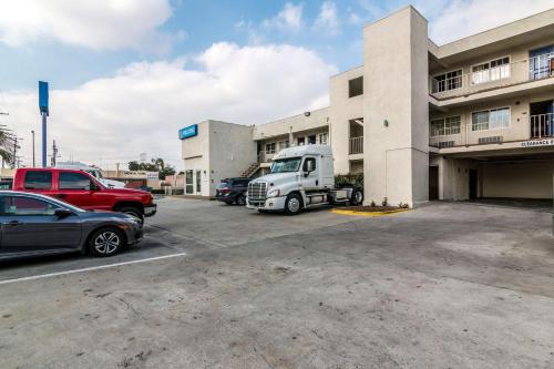 a truck parked in a parking lot in front of a building at Motel 6 Bell Gardens, CA - Los Angeles in Bell Gardens