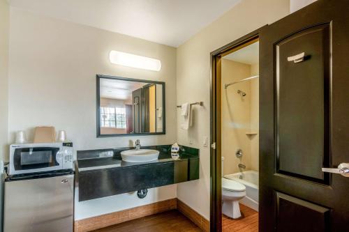 a bathroom with a sink and a toilet and a microwave at Motel 6 Bell Gardens, CA - Los Angeles in Bell Gardens
