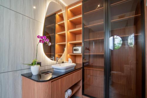 a bathroom with a sink and a mirror at Nidya Villa Canggu in Canggu
