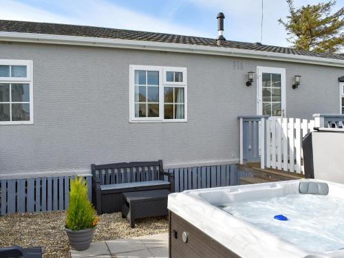 a hot tub in the backyard of a house at Eryl Mor Lodge in Amlwch