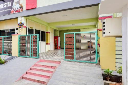 a building with doors and a staircase in front of it at Hotel O PS5 Home Stay in Tirupati