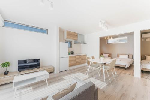 a living room with a couch and a table at SEIMU Kohama in Osaka
