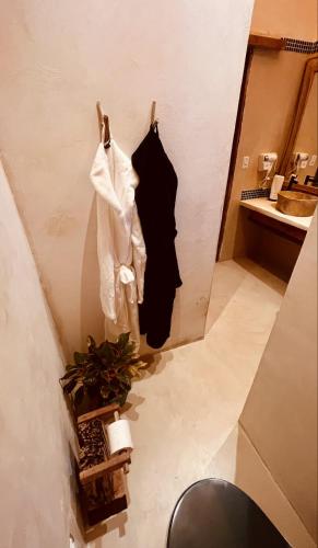 a bathroom with white towels hanging on a wall at Solar Kaeté - Suíte Varandas - Lençóis Maranheses in Santo Amaro