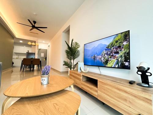 a living room with a large flat screen tv on a wall at Tulip Residences by Manhattan Group in Shah Alam