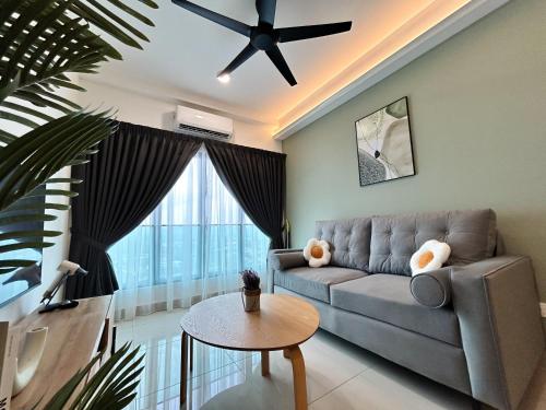 a living room with a couch and a ceiling fan at Tulip Residences by Manhattan Group in Shah Alam