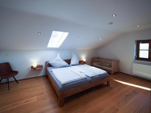 a bedroom with a bed with a skylight at Lapperhof in Waging am See