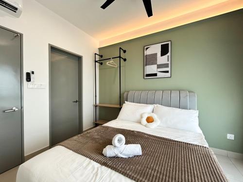 a bedroom with a bed with towels on it at Tulip Residences by Manhattan Group in Shah Alam