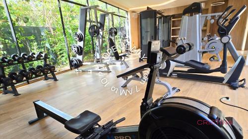 a gym with a bunch of equipment in a room at Apartment with Private Jacuzzi, Rooftop Pools & Free beach club in Tulum